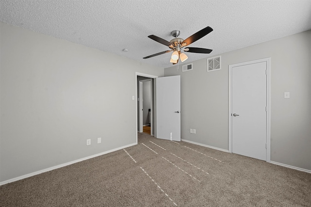 unfurnished bedroom with visible vents, a textured ceiling, and carpet floors