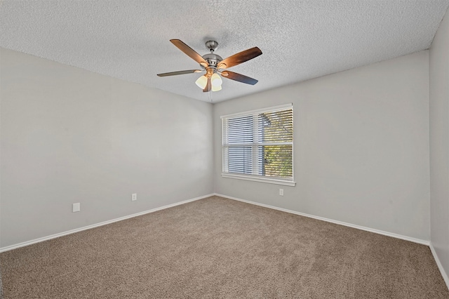 empty room with a ceiling fan, baseboards, carpet floors, and a textured ceiling