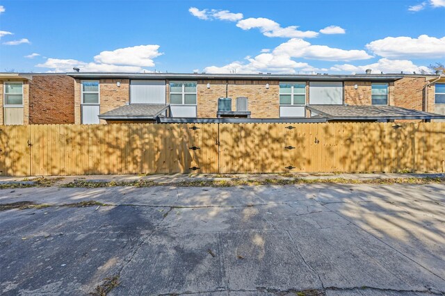 exterior space with brick siding and fence