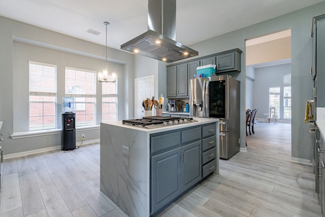 kitchen with light wood-style floors, appliances with stainless steel finishes, gray cabinets, and island range hood