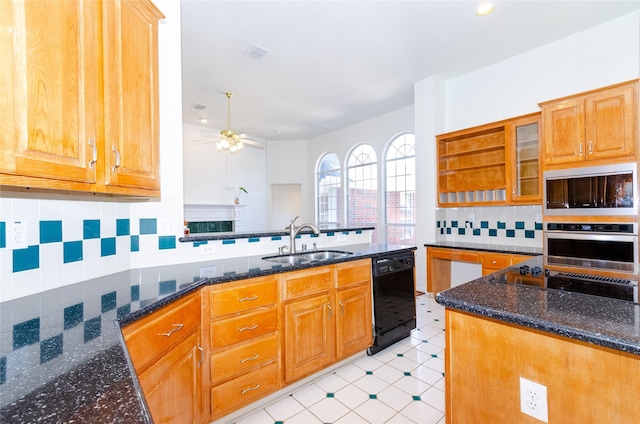 kitchen with visible vents, black appliances, dark stone counters, and a sink