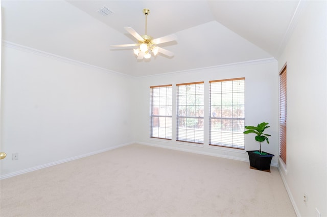 carpeted spare room featuring visible vents, ornamental molding, a ceiling fan, baseboards, and vaulted ceiling