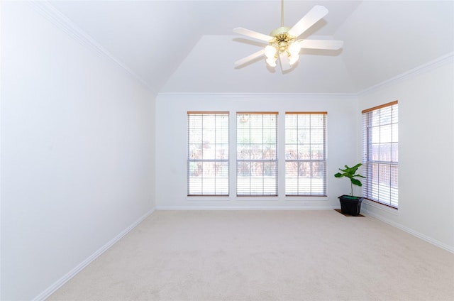 carpeted spare room featuring baseboards, a ceiling fan, lofted ceiling, and ornamental molding