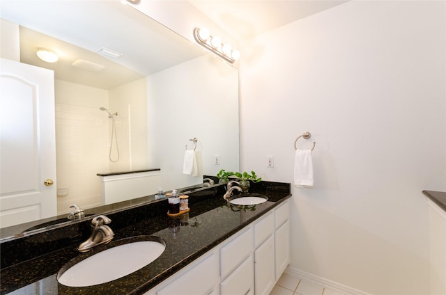 bathroom with double vanity, baseboards, and a sink