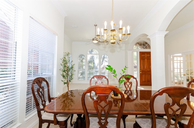 dining room featuring arched walkways, a notable chandelier, ornate columns, and ornamental molding