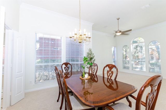 dining room with visible vents, light colored carpet, crown molding, and ceiling fan with notable chandelier