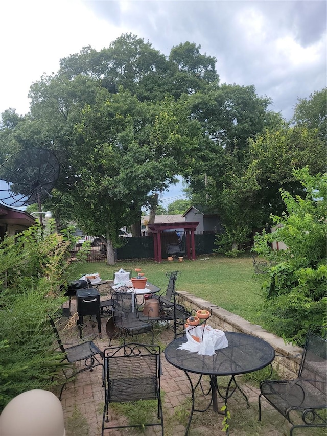 view of patio / terrace with outdoor dining space and fence