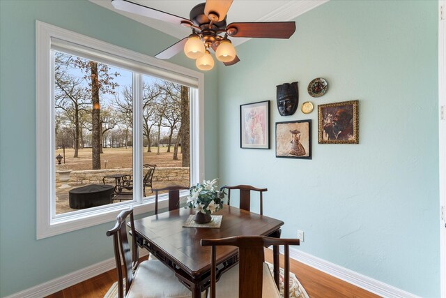 dining space with plenty of natural light, baseboards, and wood finished floors