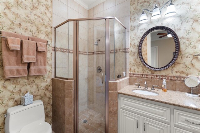 bathroom with a shower stall, wallpapered walls, and ornamental molding