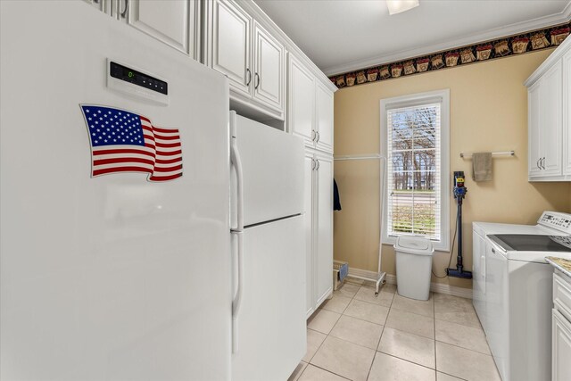 interior space featuring baseboards, ornamental molding, light tile patterned flooring, cabinet space, and independent washer and dryer