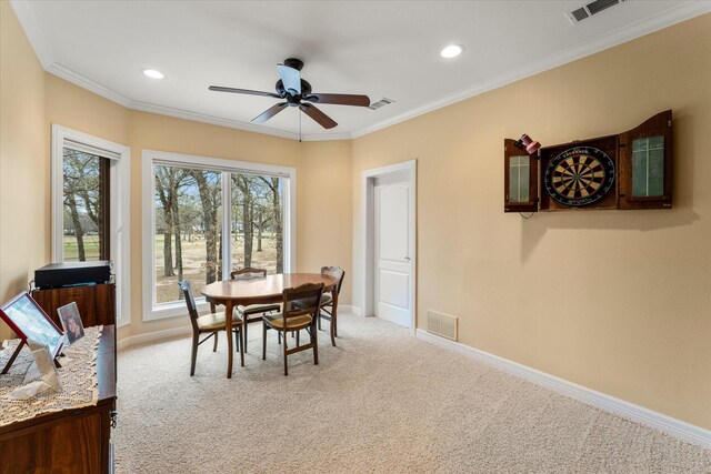 dining area with crown molding, visible vents, and carpet floors