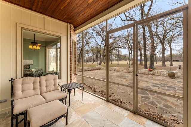 sunroom featuring plenty of natural light and wood ceiling