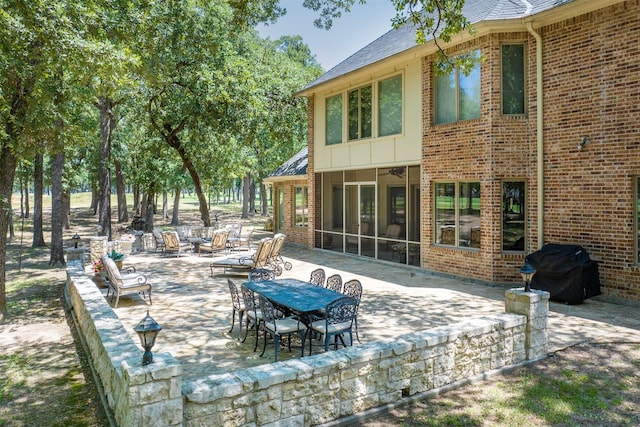 view of patio / terrace with a sunroom and grilling area