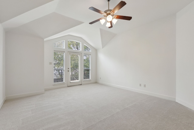 unfurnished room featuring light colored carpet, ceiling fan, baseboards, and vaulted ceiling