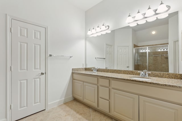 full bathroom with a sink, double vanity, a shower stall, and tile patterned floors