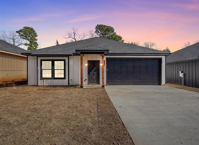 view of front facade with driveway, roof with shingles, a garage, and board and batten siding