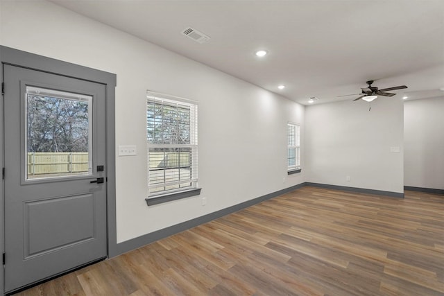 unfurnished room with visible vents, recessed lighting, baseboards, and wood finished floors