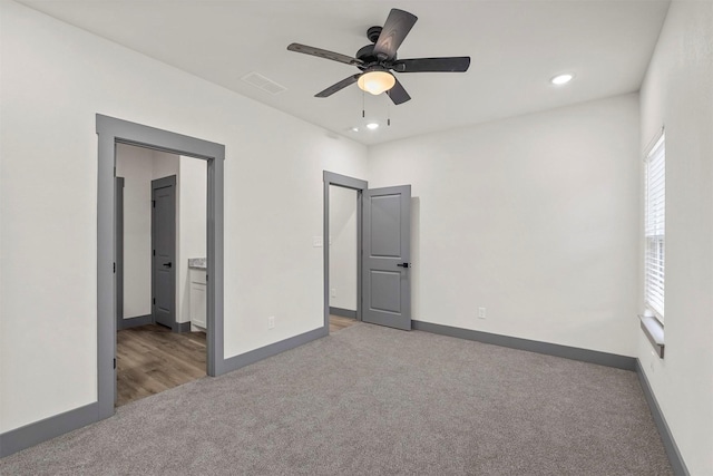 unfurnished bedroom featuring visible vents, baseboards, carpet flooring, recessed lighting, and ensuite bathroom