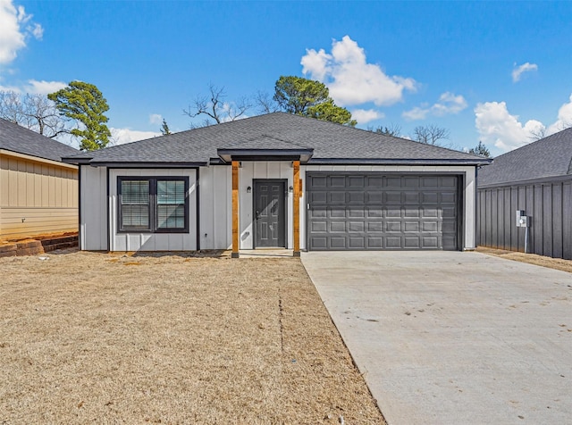 view of front of property with a garage, board and batten siding, driveway, and a shingled roof