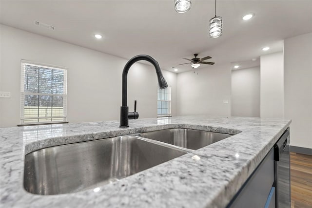 details with a sink, visible vents, light stone countertops, and recessed lighting