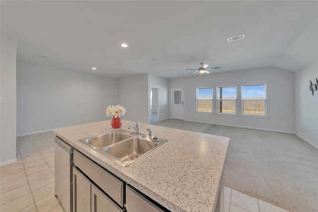 kitchen with a sink, visible vents, stainless steel dishwasher, and light countertops