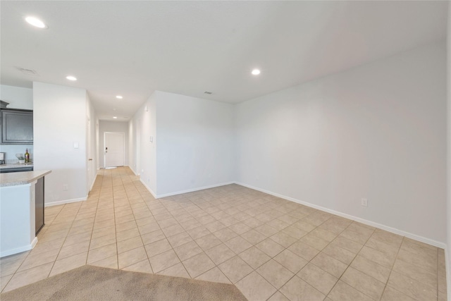 spare room with recessed lighting, baseboards, and light tile patterned floors