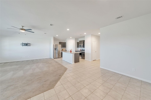 unfurnished living room with baseboards, visible vents, recessed lighting, ceiling fan, and light carpet