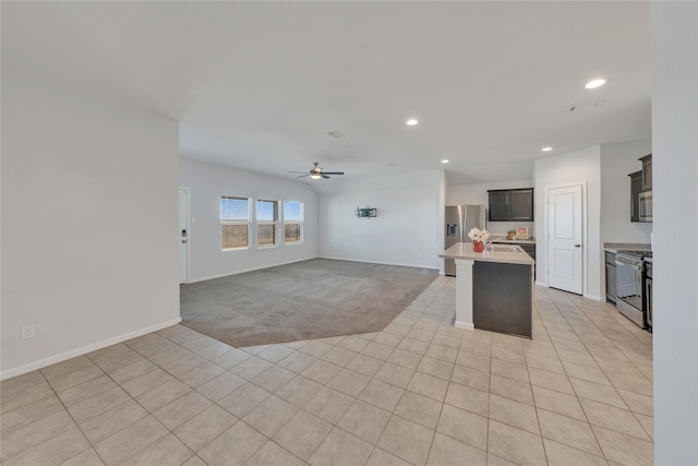 kitchen with a ceiling fan, visible vents, appliances with stainless steel finishes, light colored carpet, and open floor plan