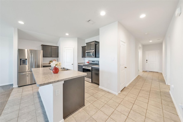 kitchen with recessed lighting, stainless steel appliances, light countertops, and a sink