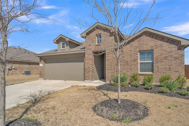 view of front of house featuring brick siding, cooling unit, concrete driveway, and a garage