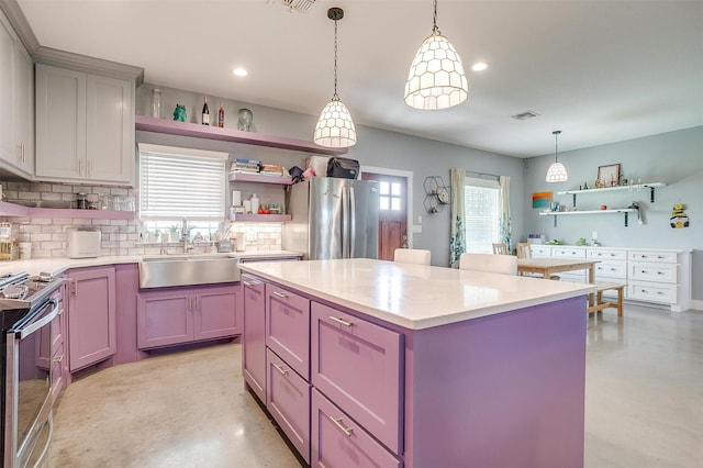 kitchen featuring open shelves, visible vents, stainless steel appliances, and a sink
