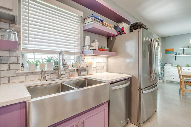 kitchen featuring a sink, open shelves, finished concrete floors, appliances with stainless steel finishes, and light countertops