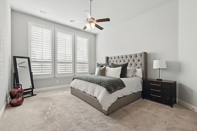 carpeted bedroom with visible vents, ceiling fan, and baseboards