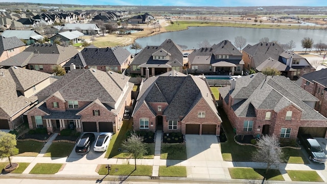 bird's eye view with a residential view and a water view