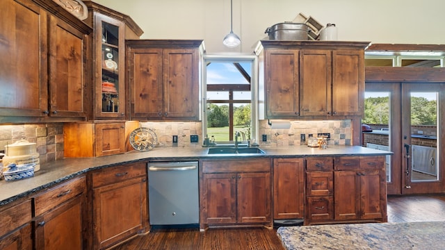 kitchen with dark wood finished floors, dishwasher, tasteful backsplash, and a sink