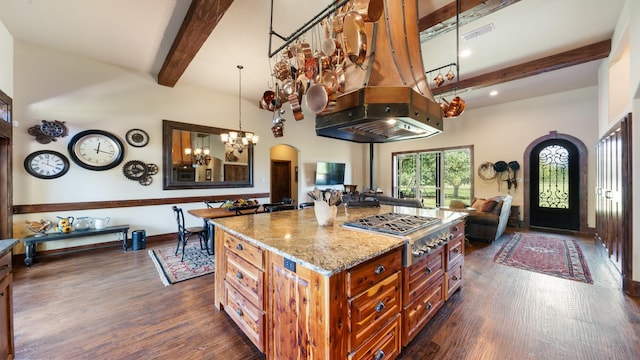 kitchen with visible vents, open floor plan, light stone counters, stainless steel gas stovetop, and arched walkways