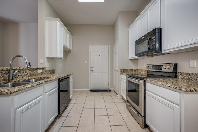 kitchen featuring light tile patterned flooring, stone countertops, a sink, black appliances, and white cabinets