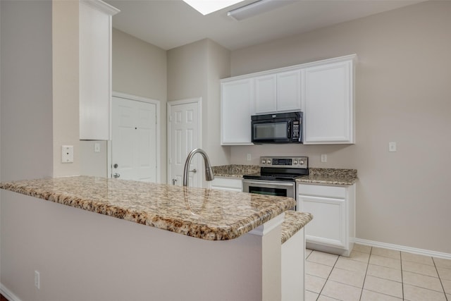 kitchen featuring a peninsula, a sink, stainless steel range with electric cooktop, black microwave, and white cabinetry