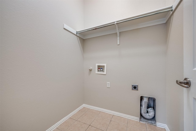 washroom featuring hookup for a gas dryer, light tile patterned floors, hookup for an electric dryer, hookup for a washing machine, and laundry area