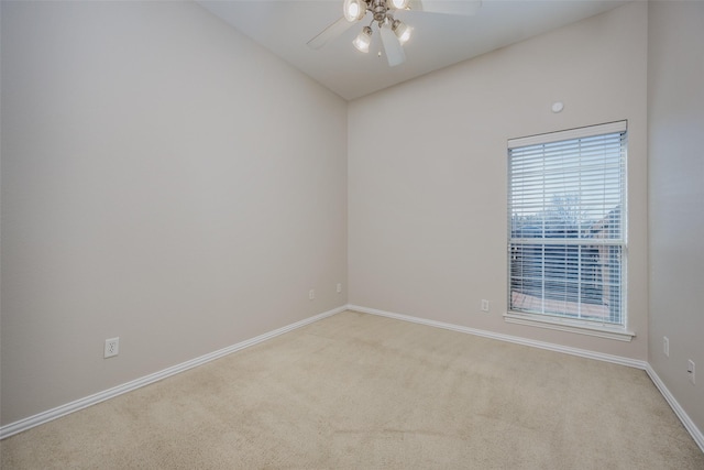 unfurnished room featuring lofted ceiling, baseboards, carpet floors, and ceiling fan