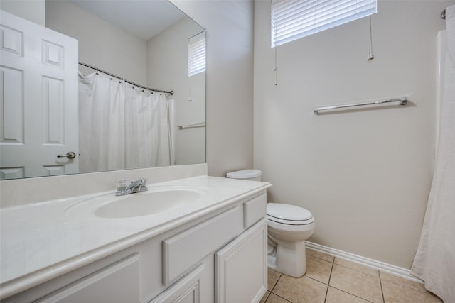 bathroom with tile patterned flooring, toilet, vanity, and baseboards