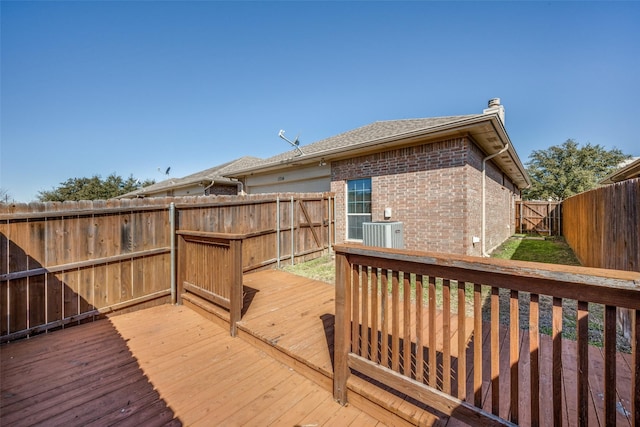 deck featuring cooling unit and a fenced backyard