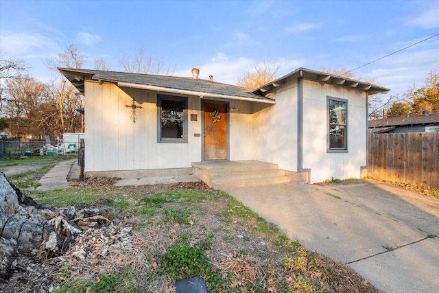 bungalow-style home featuring fence