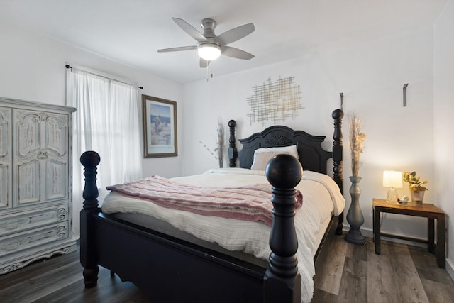 bedroom with a ceiling fan, wood finished floors, and baseboards