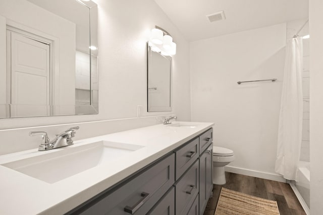 full bath featuring wood finished floors, toilet, baseboards, and a sink