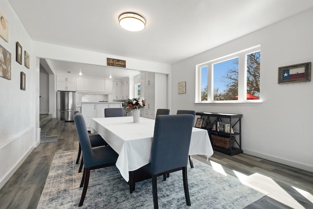 dining space with dark wood-type flooring and baseboards