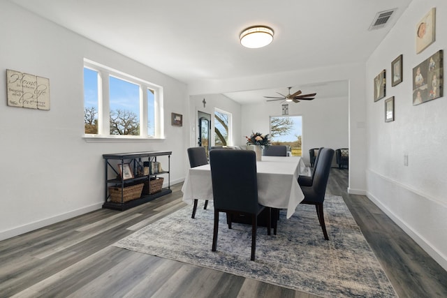 dining space featuring visible vents, baseboards, and dark wood-style flooring