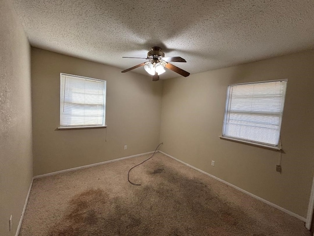 empty room with carpet, a healthy amount of sunlight, and baseboards