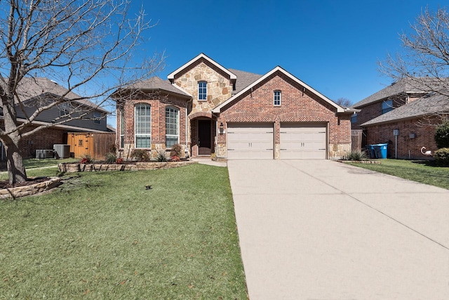 traditional home with stone siding, brick siding, an attached garage, and a front yard