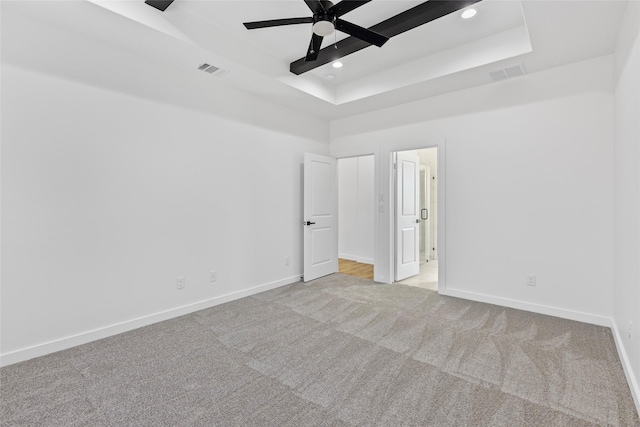 spare room with light carpet, visible vents, recessed lighting, and baseboards